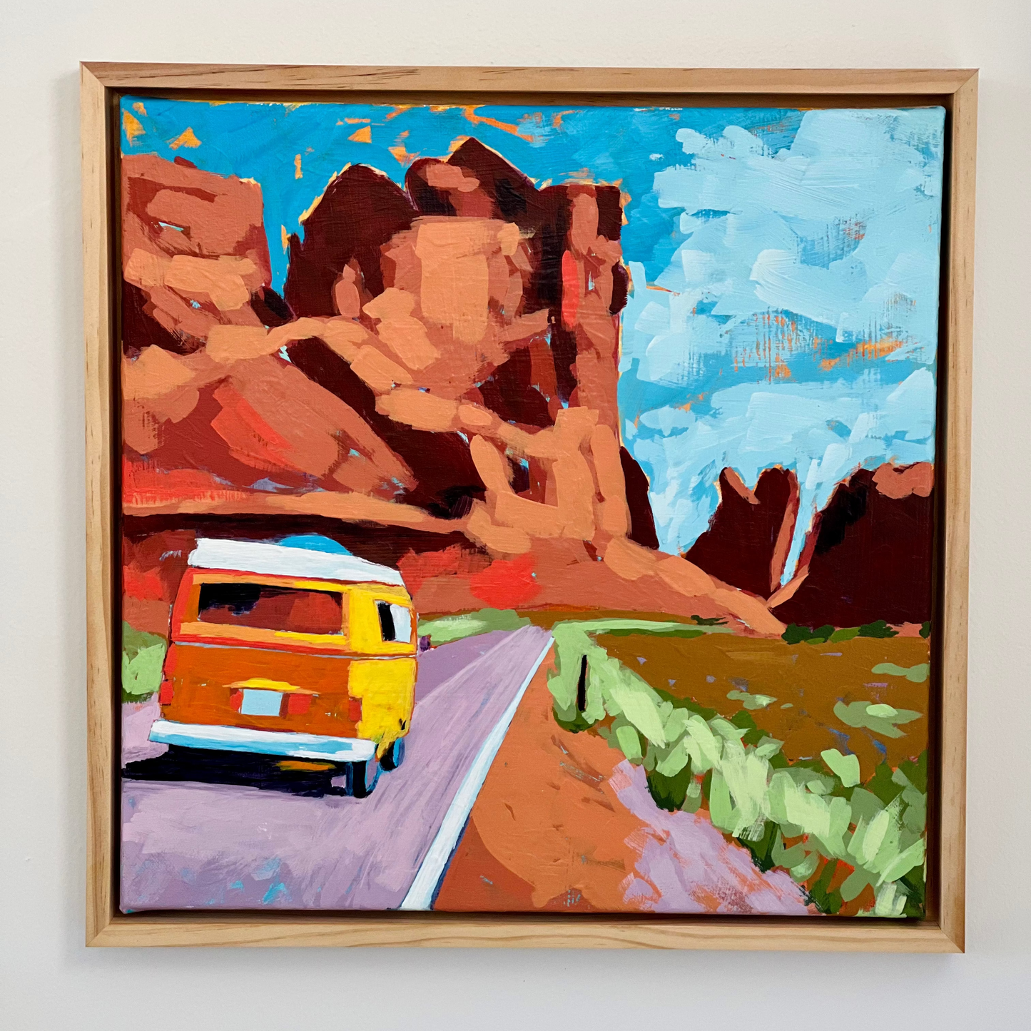 Framed Mallory Paige Original paiting of an orange VW campervan on a road with desert landscape